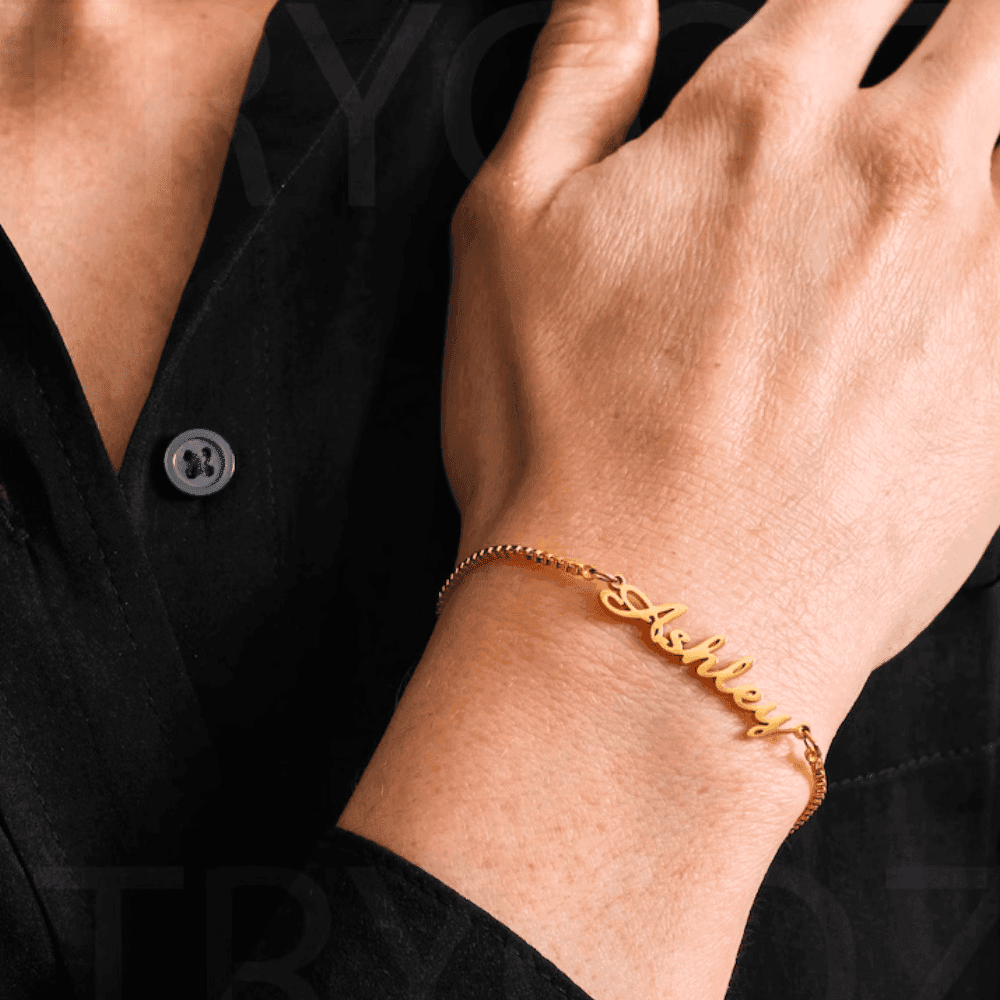Gold custom name chain bracelet worn on wrist, perfect for personalized gifts and fashion accessories