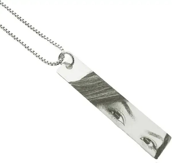 Personalized photo necklace featuring a custom engraved image on a silver pendant