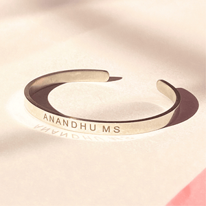 Customized name chain online India featuring a sleek silver cuff with engraved name ANANDHU MS