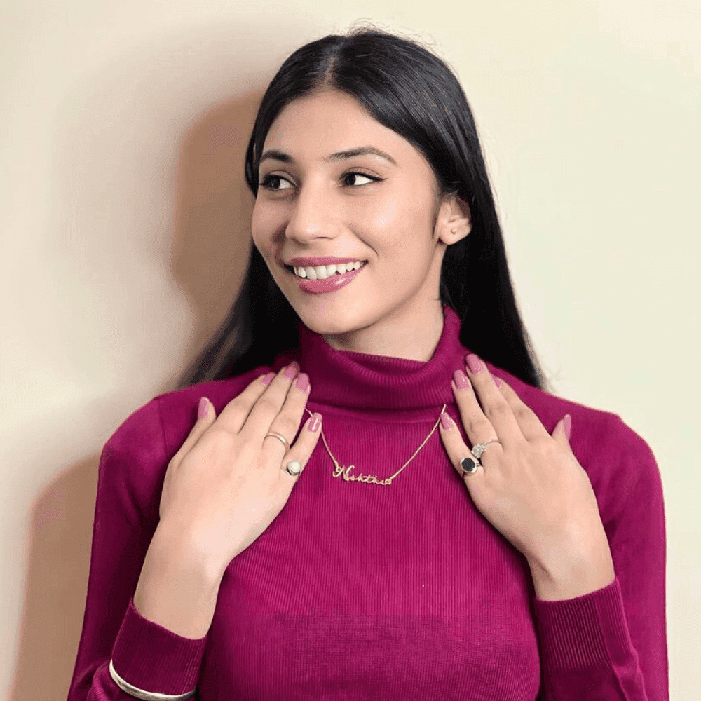 Woman wearing a Customized Name Necklace in gold with a stylish outfit and accessories