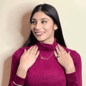 Woman wearing a Customized Name Necklace in gold with a stylish outfit and accessories