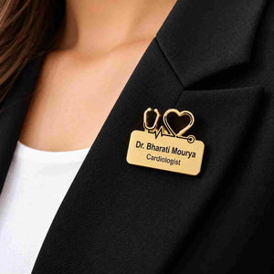 Gold personalised doctor name badge with stethoscope and heart design reading “Dr. Bharati Mourya, Cardiologist,” pinned on a black blazer.
