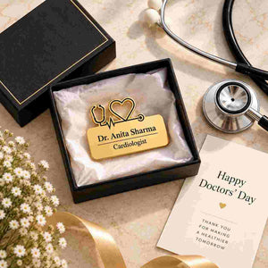 Gold personalised doctor name badge engraved “Dr. Anita Sharma, Cardiologist,” presented in a black gift box with a stethoscope and Happy Doctors’ Day card.