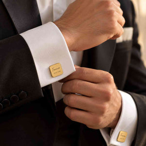 Groom wearing personalized gold square cufflinks with custom initials and date engraving
