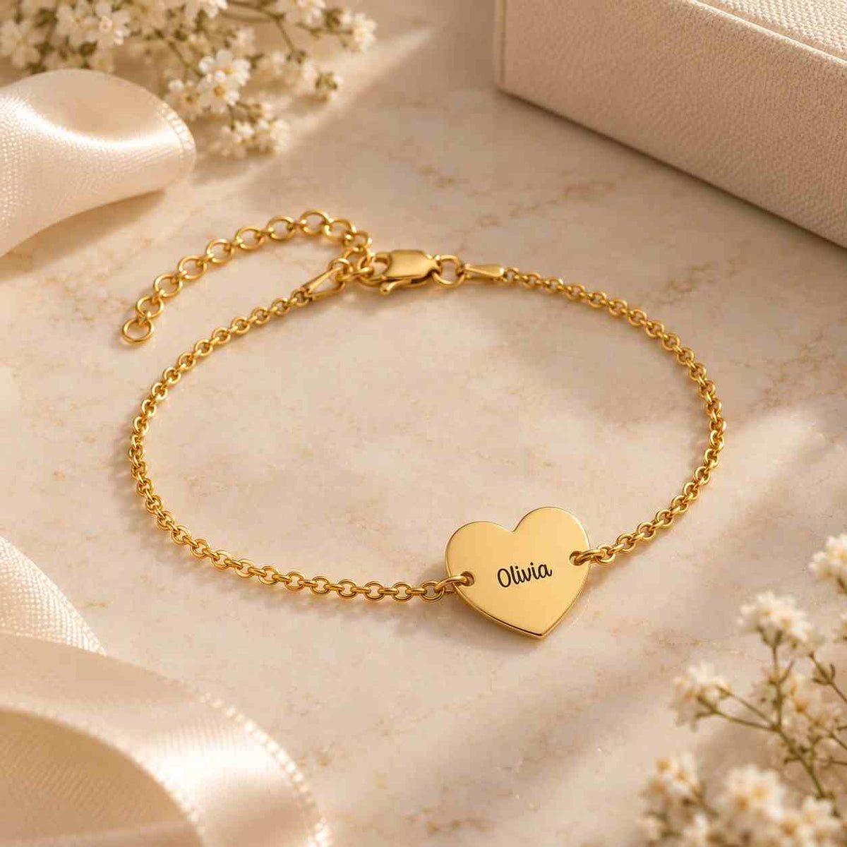 Personalized heart name bracelet in gold featuring the name Olivia on a delicate chain