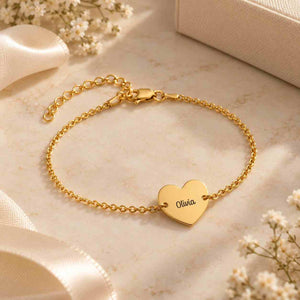 Personalized heart name bracelet in gold featuring the name Olivia on a delicate chain
