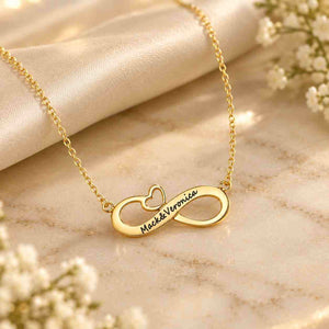 Personalized gold infinity couple name necklace engraved with Mack & Veronica on a marble surface