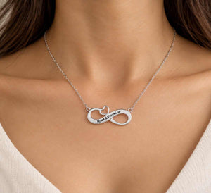Silver personalized infinity necklace with Mack & Veronica names worn around a woman’s neck
