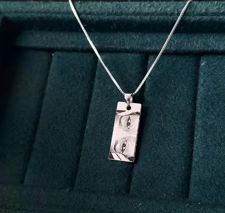 Personalized photo necklace featuring a sleek pendant with detailed engraving on a silver chain