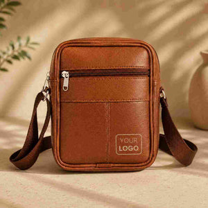 Front view of brown leather sling bag with custom logo and zip pockets