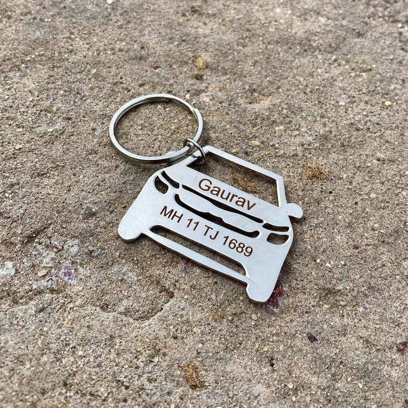 Personalized keyring with vehicle number designed in metal featuring a car silhouette and custom name