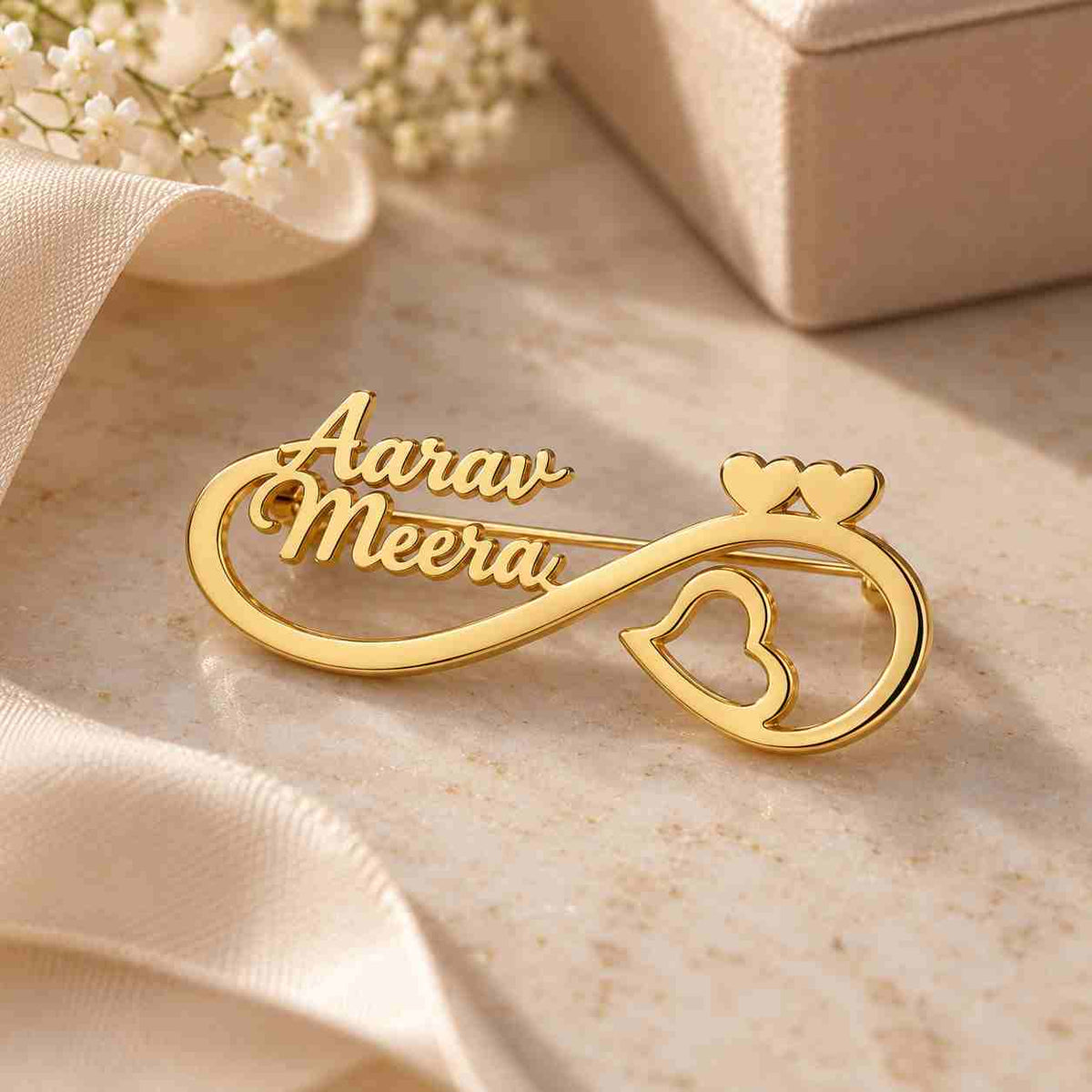Personalised Couple Name Brooch in gold featuring the names Aarav and Meera in a stylish design
