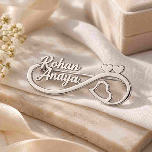 Personalised Couple Name Brooch featuring Rohan and Anaya in silver with heart and infinity design