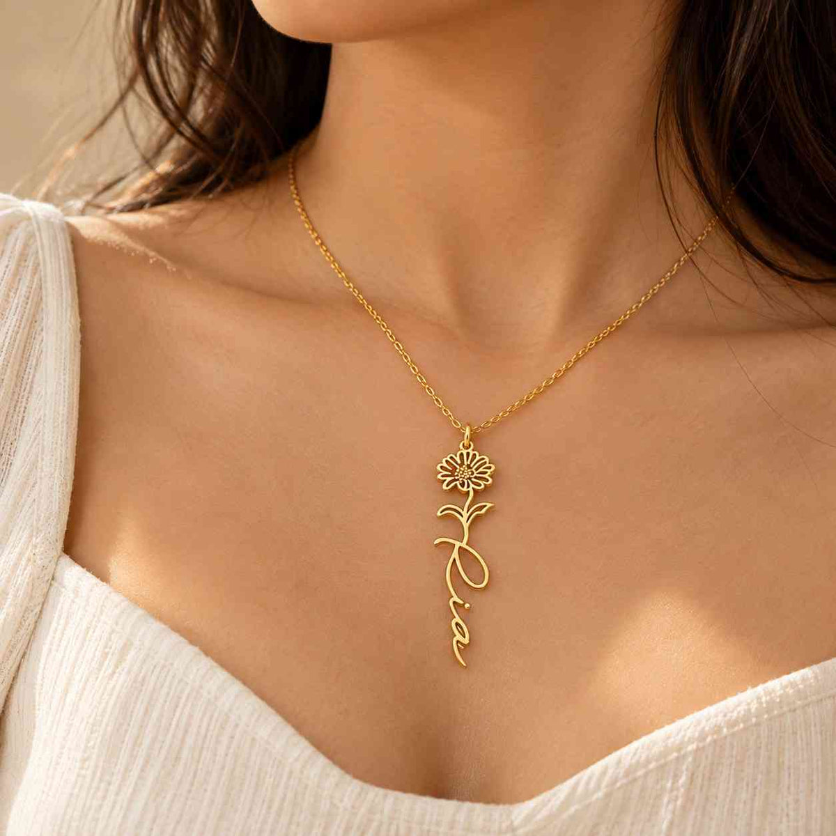 Personalized Flower Name Necklace in gold with a floral design and custom name 'Ria'.