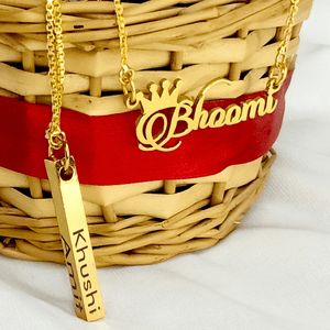 Gold personalized jewelry set featuring name necklaces 'Bhoomi' and 'Khushi' on a woven basket background