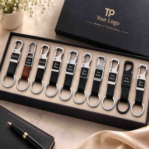 Box set of ten personalized leather keychains with custom name engraving, packed in a branded gift box
