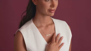 Close-up of a model in a white top wearing a delicate gold chain necklace featuring a customized Urdu name pendant by ANKX.