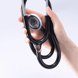 Hand holding a black stethoscope with a personalized stethoscope name tag for medical professionals