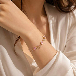 Woman wearing gold Tulip Bracelets with pink crystals on wrist