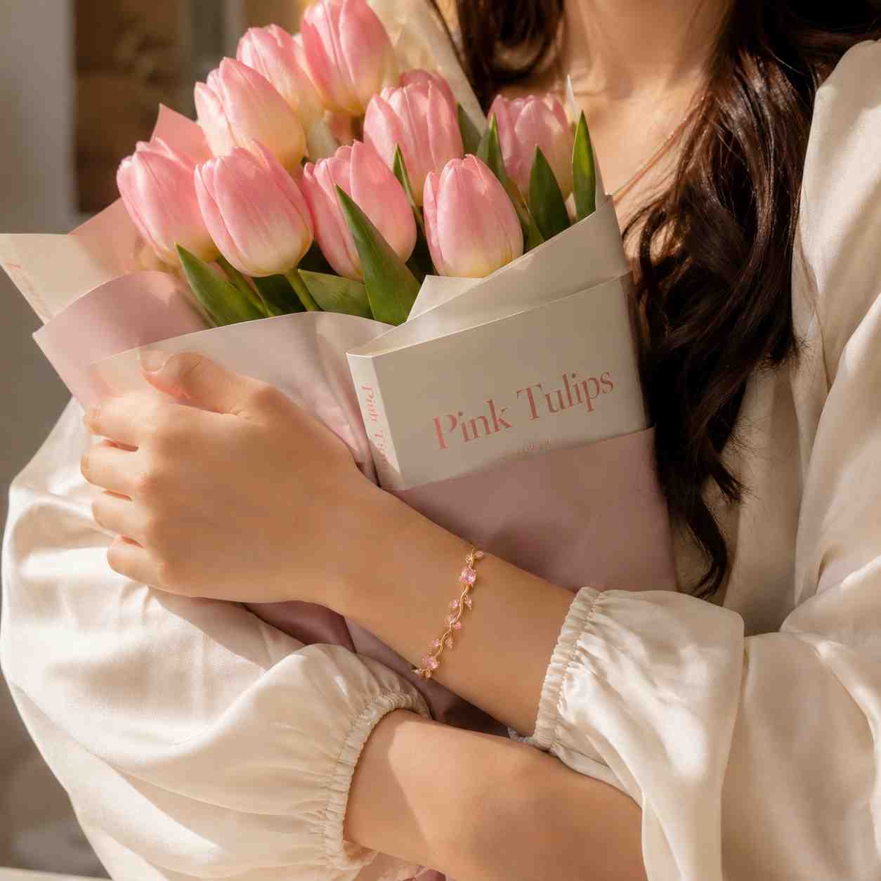 Woman wearing pink crystal Tulip Bracelets while holding tulip bouquet