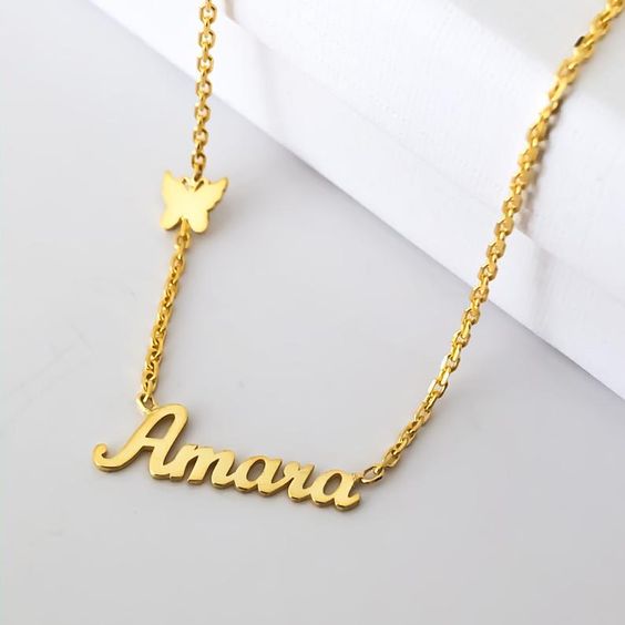 Ankx.in unique custom name necklace gift in gold featuring the name Amara and a butterfly charm